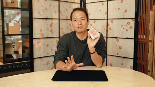 Das Beitragsbild für das Tutorial Video für diesen Pinky Break Zaubertrick zeigt den Zauberkünstler Yuta, der ein Kartendeckt in der Hand hält.