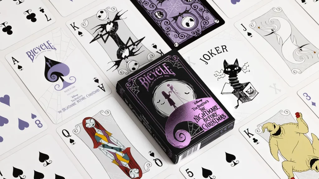 Kartenspiel Bicycle A Nightmare Before Christmas liegt auf weißem Untergrund umgeben von Spielkarten. Nightmare Before Christmas Merchandise, Bicycle Spielkarten